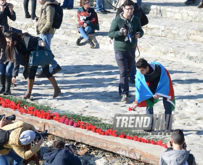 Baku residents bringing flowers to Seaside Boulevard to honor missing oil workers.  Azerbaijan, Dec.07, 2015